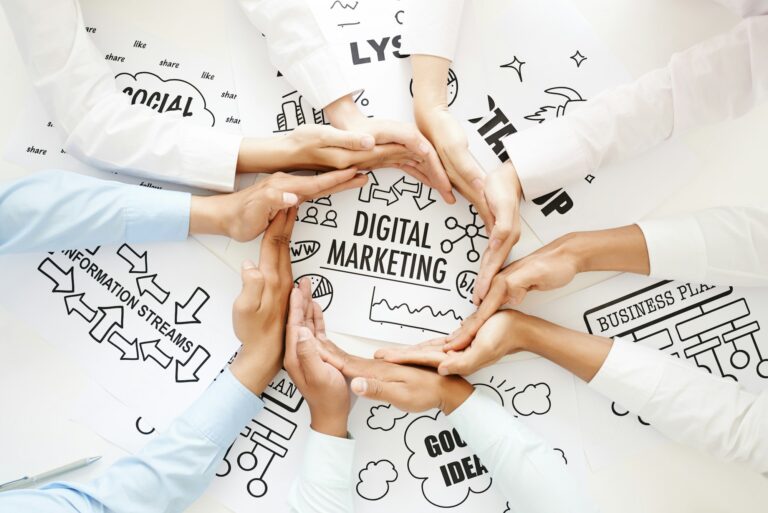 A group of hands circling the word Digital marketing